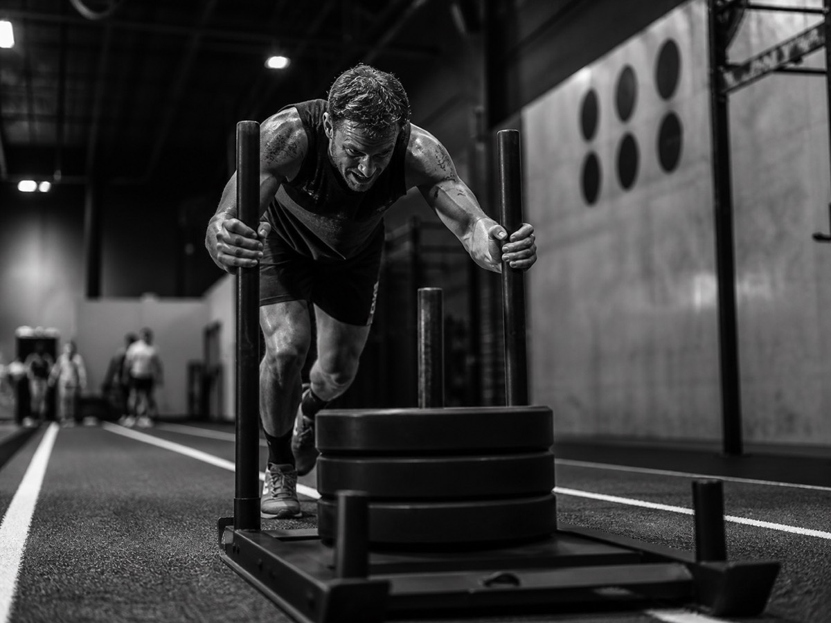An athlete pushing a heavy sled